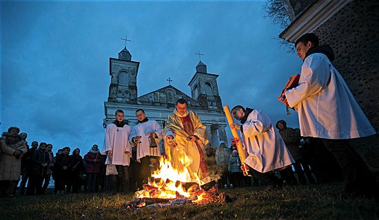 A priest and worshippers take part in the Easter Vigil in the village of Ragotna, near Minsk, Belarus, April 4, 2015.